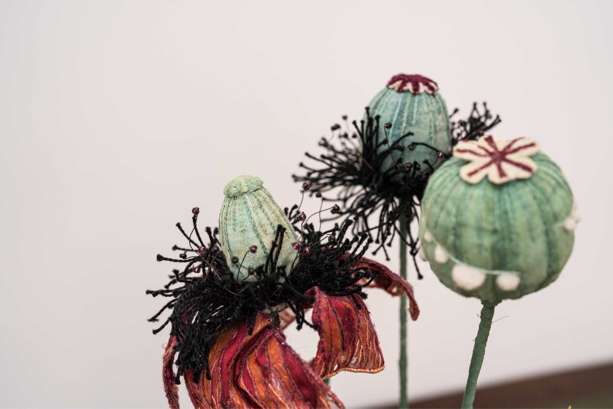Dyed textile poppy and seed heads
