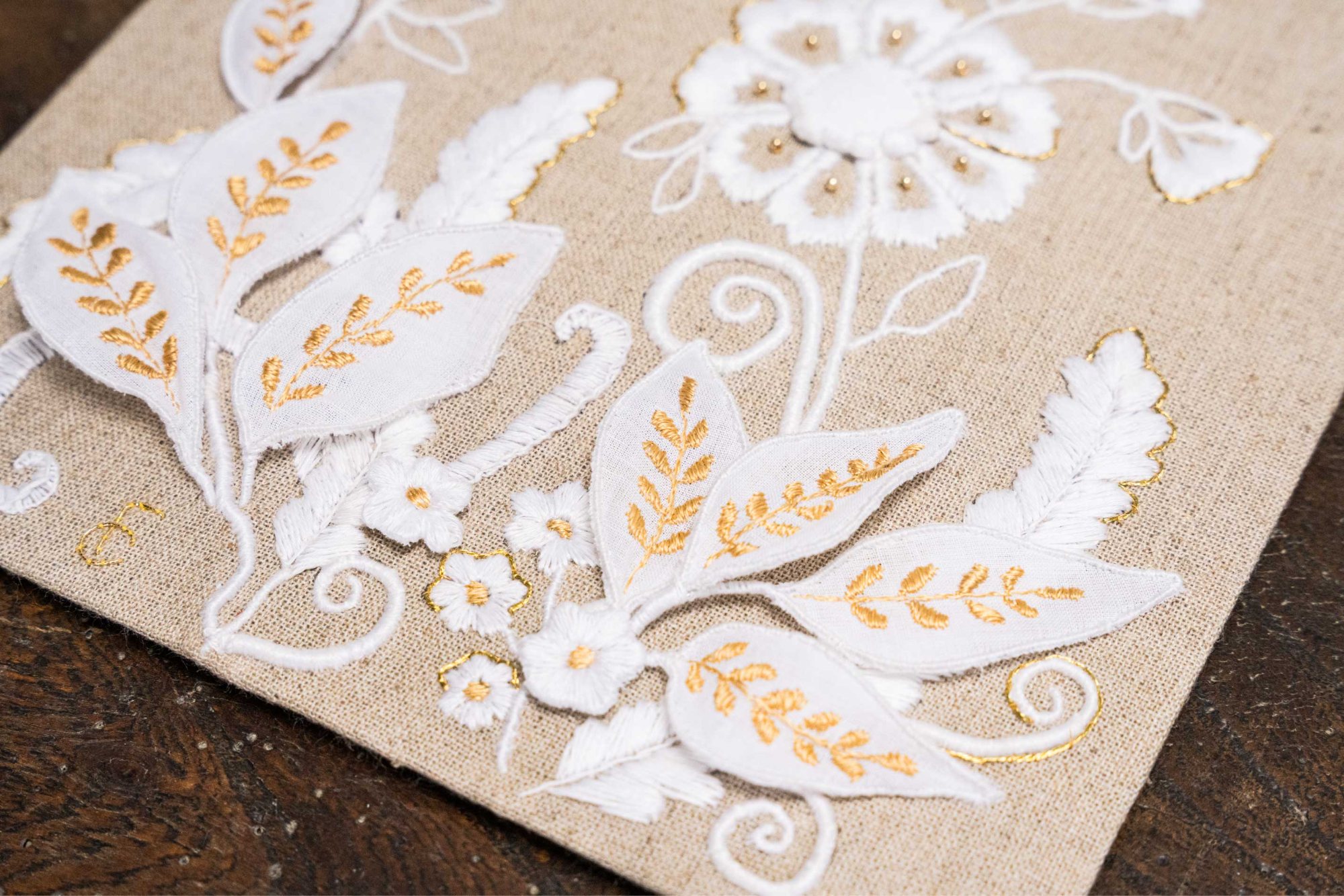 Padded whitework flowers with gold bead centres